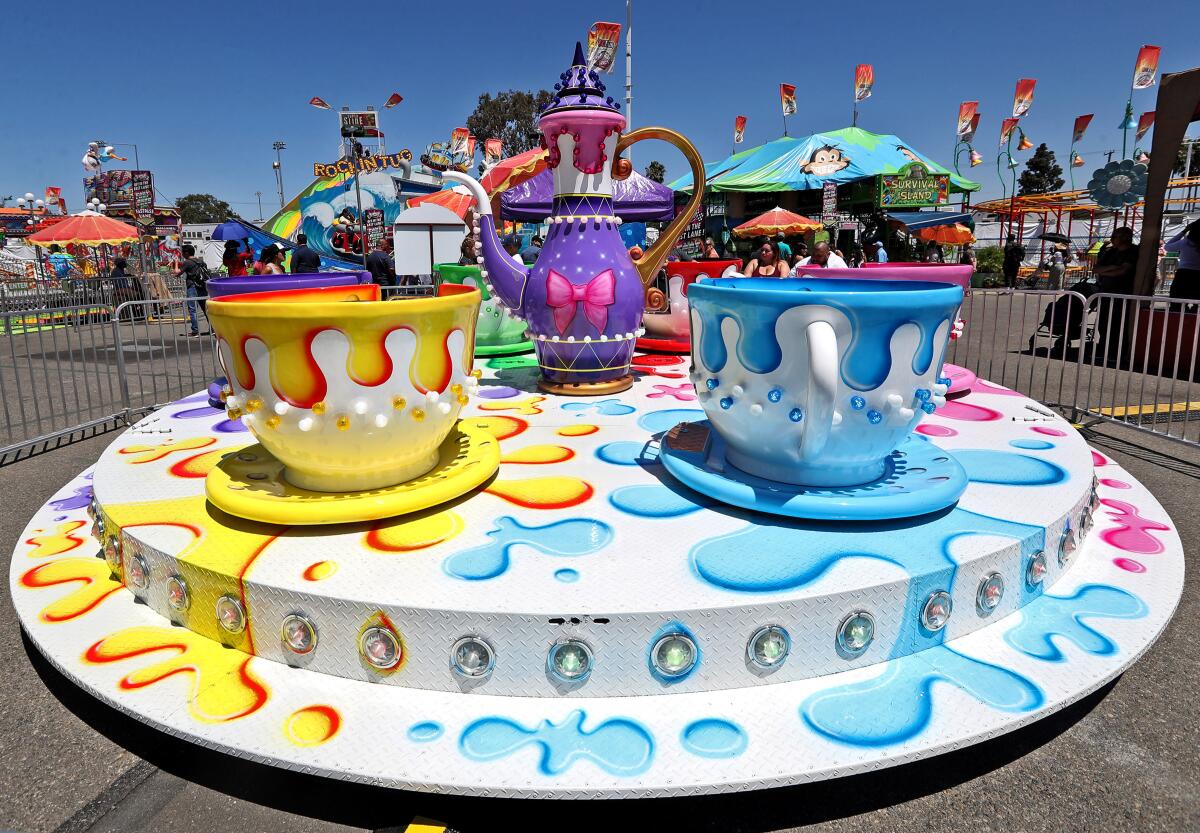 Visitors ride the Tea Cups at last year's Orange County Fair in Costa Mesa. The fairgrounds board of directors decided Thursday not to raise ticket prices for the fair, but the year-round parking fee will increase to $10.