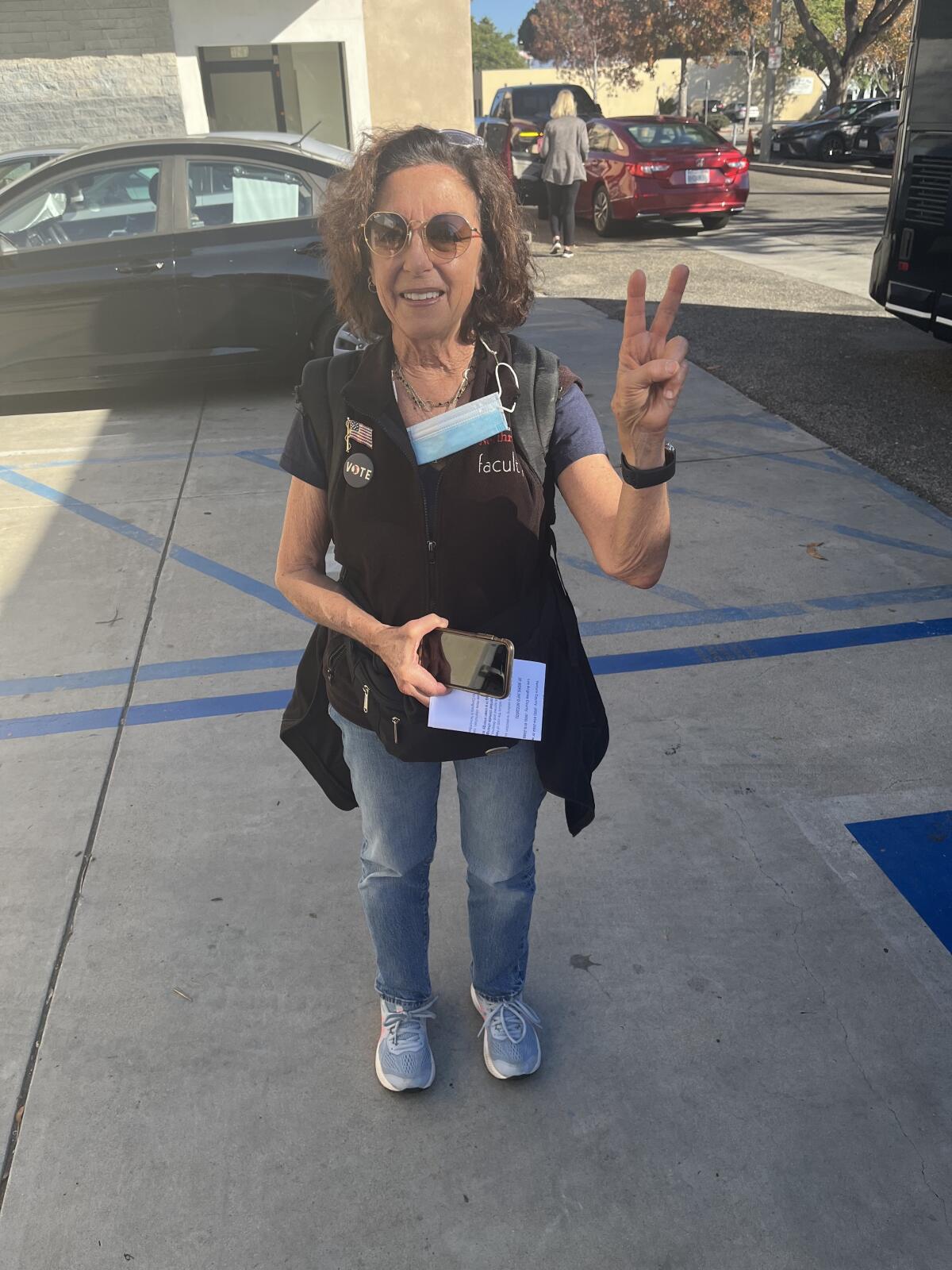 Terri Lisagor, a retired professor who lives in Camarillo, flashes a peace sign.