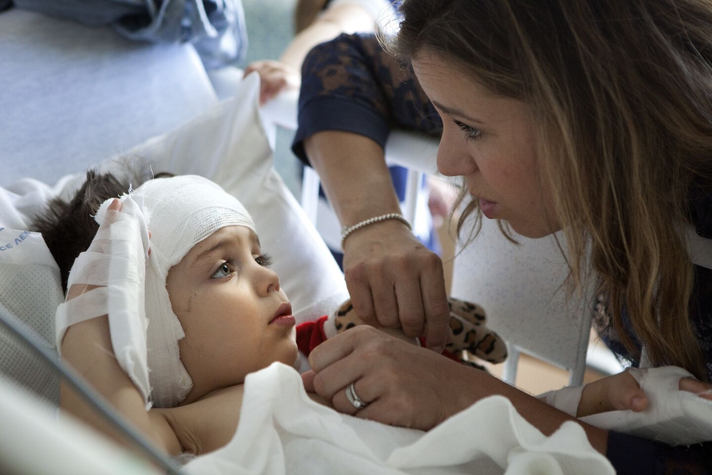 Sophie Gareau looks in on her son Auguste as the 3-year-old recovers after surgery at Children's Hospital Los Angeles.