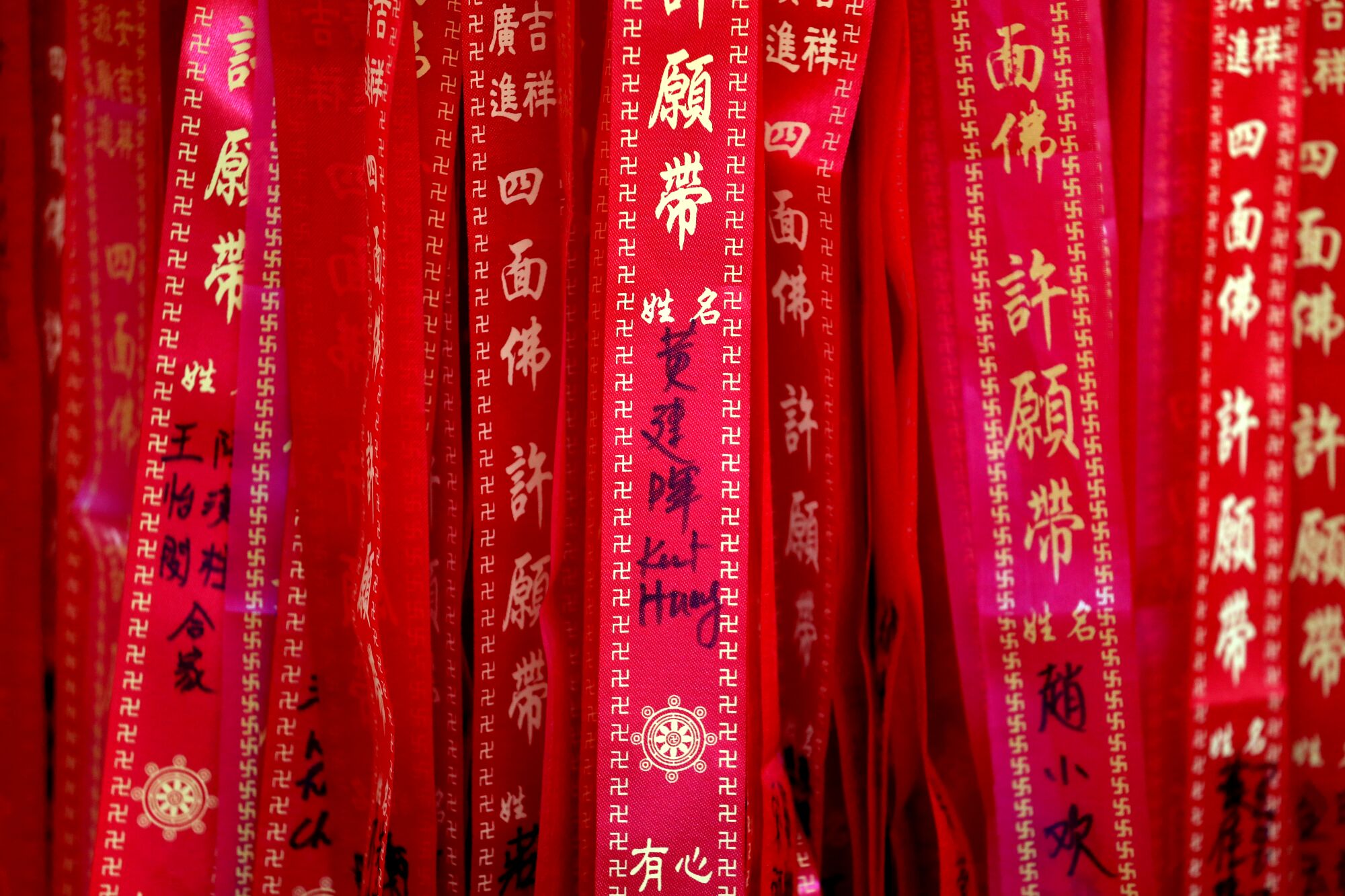 Wishing ties are left as offerings at the four-faced Buddha shrine at MP Prajna Buddhist Mission in Monterey Park.