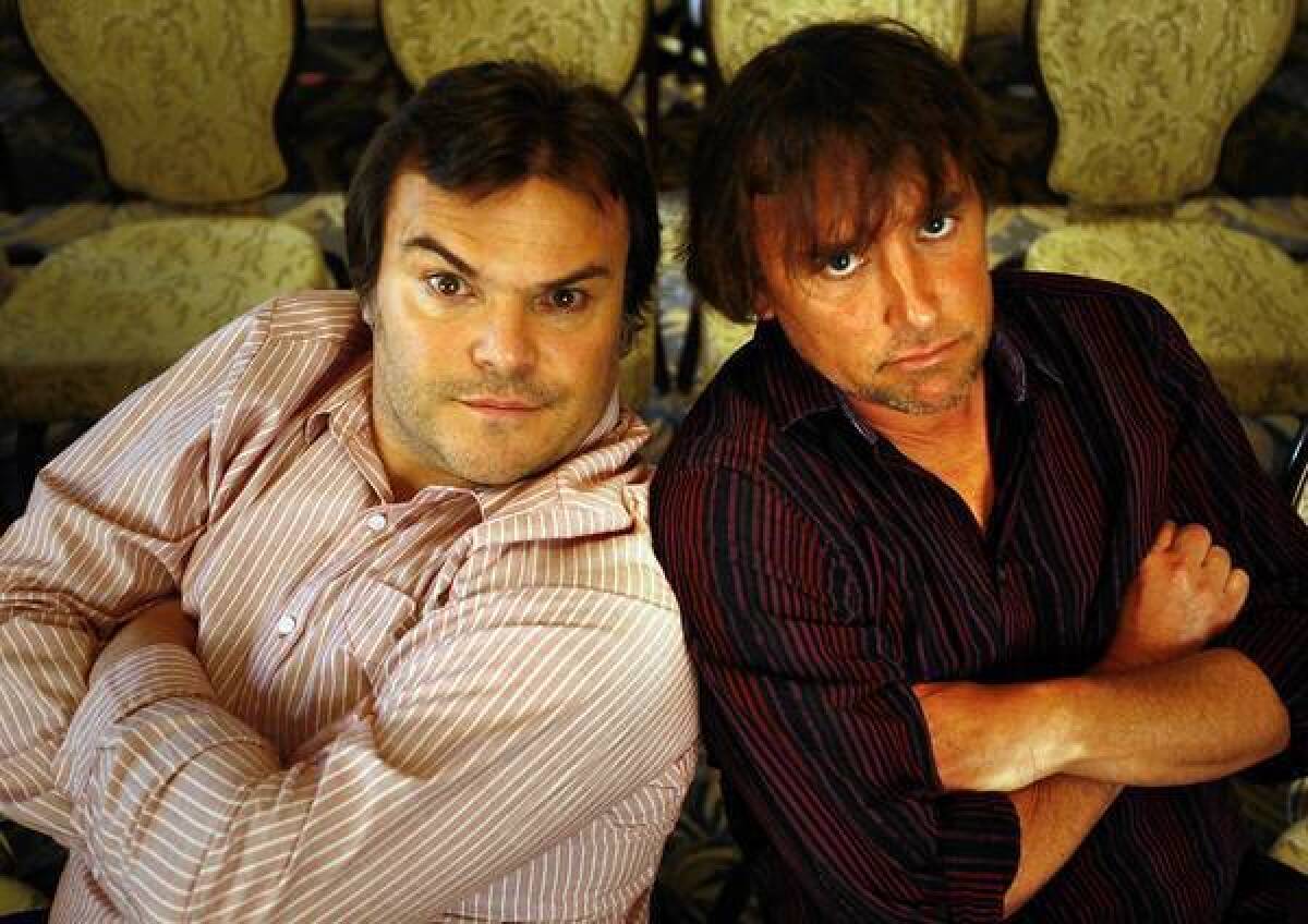 Jack Black, left, and writer–director Richard Linklater horse around before they talk about their collaboration on "Bernie."