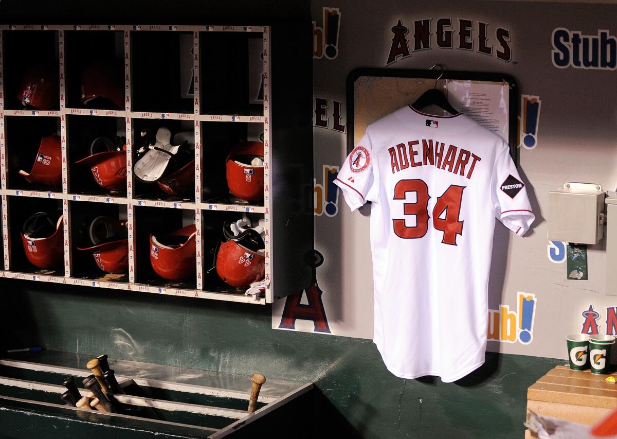 The jersey of Angels pitcher Nick Adenhart hangs in the dugout before a game against the Boston Red Sox on April 10, 2009.