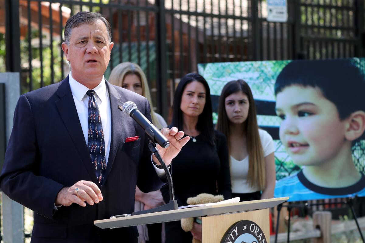 With 6-year-old Aiden Leos' family members behind him, O.C. supervisor Donald P. Wagner speaks at a press conference.