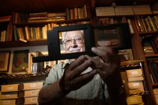 WEST HILLS, CA -- May 1, 2013--Ernie Marquez, 89, holds a Lantern slide projector slide holder, from the 1890s, in a location he prefers not to disclose, where he houses his large collection of California history in books, artifacts and more than 4,000 pictures, May 1, 2013. (Jay L. Clendenin / Los Angeles Times)