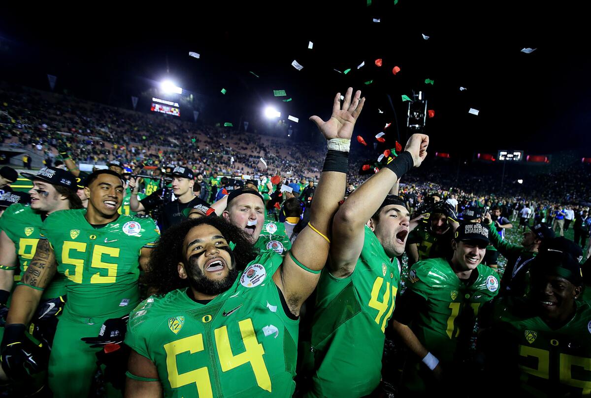 Ducks players celebrate after their victory over the Seminoles in a College Football Playoff semifinal at the Rose Bowl.