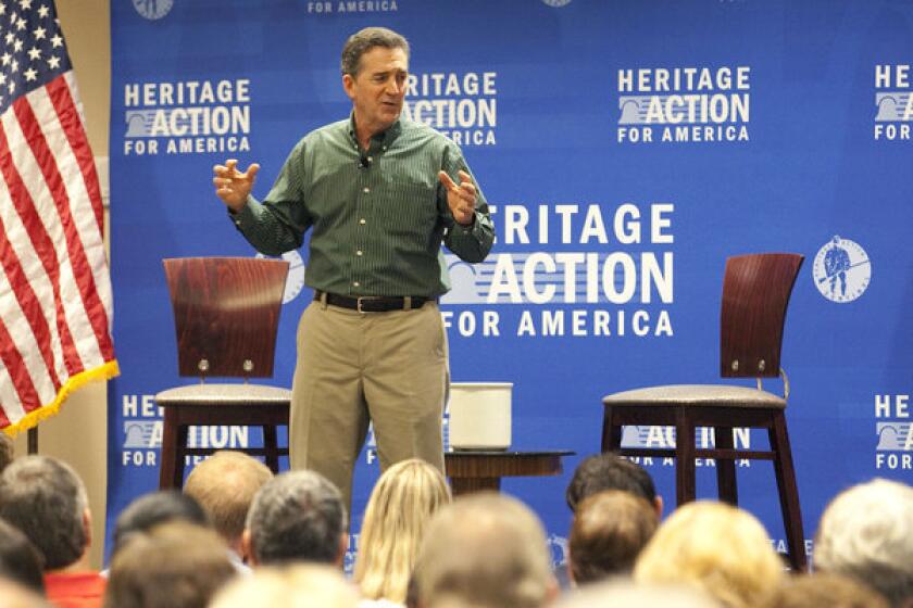 The Heritage Foundation president and former Sen. Jim DeMint speaks to a town hall meeting held at the Crowne Plaza Tampa-Westshore in Tampa, Fla. on Aug. 21. "There's no question in my mind that I have more influence now on public policy than I did as an individual senator," DeMint told NPR recently.