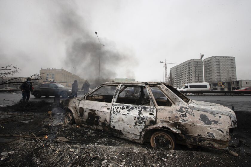 A car, which was burned after clashes, is seen on a street in Almaty, Kazakhstan, Friday, Jan. 7, 2022. Kazakhstan's president authorized security forces on Friday to shoot to kill those participating in unrest, opening the door for a dramatic escalation in a crackdown on anti-government protests that have turned violent. The Central Asian nation this week experienced its worst street protests since gaining independence from the Soviet Union three decades ago, and dozens have been killed in the tumult. (AP Photo/Vasily Krestyaninov)