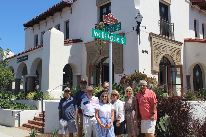 The Rancho Santa Fe Association board and Manager Christy Whalen with the new street sign toppers.