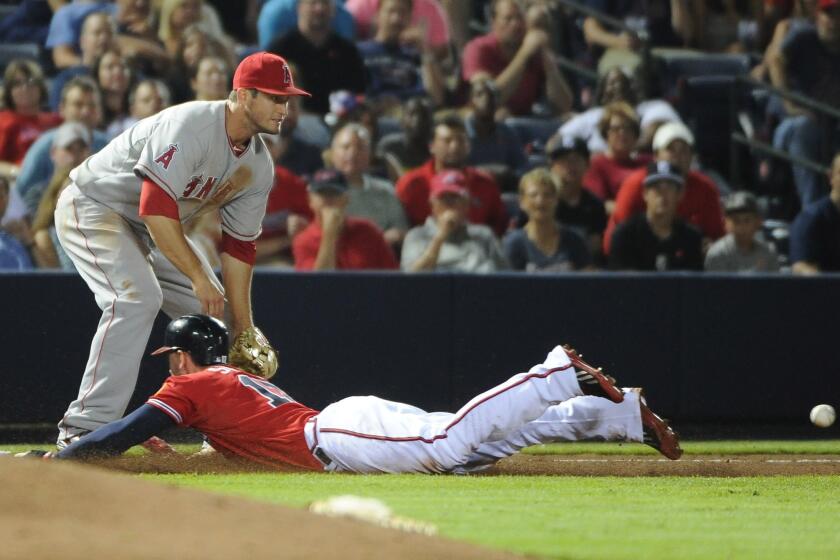 Atlana's Jordan Schafer dives head-first into third base to beat the throw to David Freese during the Braves' 4-3 victory Friday over the Angels.