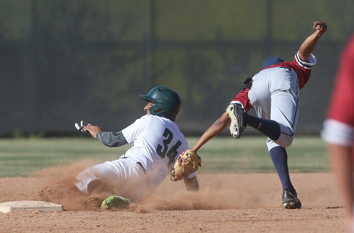 Sage Hill School's Ashwin Chona (34) is tagged out by St. Margaret's Hunter Smith on a slide to second base in a San Joaquin League game on Tuesday.