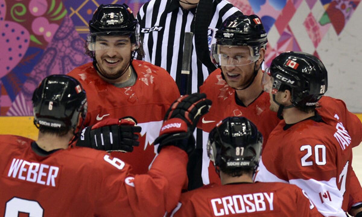 Canada defenseman Drew Doughty, top left, celebrates with teammates (from left to right) Shea Weber, Sidney Crosby, Jeff Carter and John Tavares after scoring a goal during Sunday's win over Finland. Doughy has been an offensive force for Canada through its first three Olympic games.