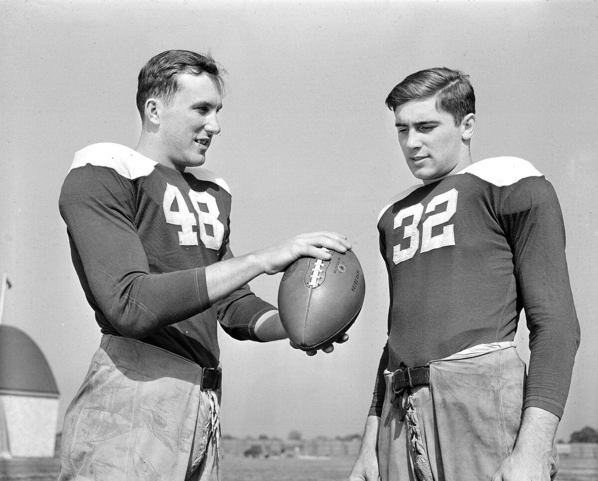 Angelo Bertelli explains to teammate Johnny Lujack how those famous passes are thrown.