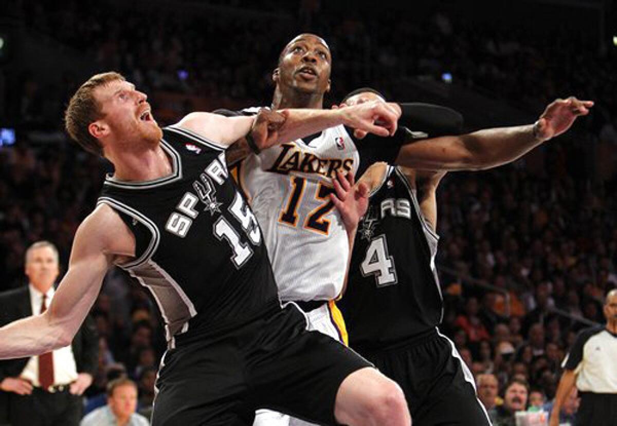 Dwight Howard, Matt Bonner and Danny Green battle for position during the fourth quarter of the Lakers' 91-86 win over the San Antonio Spurs.