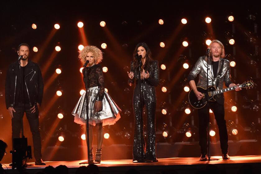 Jimi Westbrook, Kimberly Schlapman, Karen Fairchild and Phillip Sweet of Little Big Town perform at the CMA Awards at Bridgestone Arena on Nov. 4, 2015 in Nashville, Tenn.
