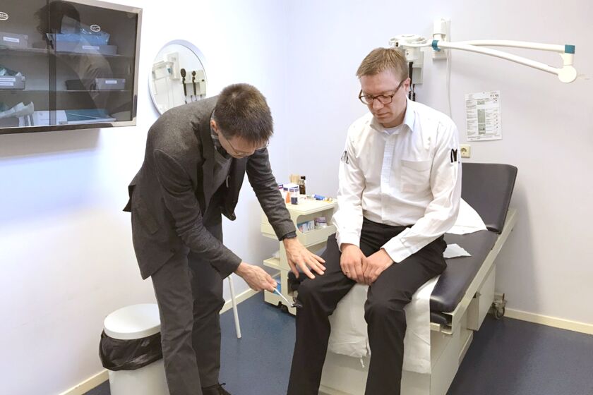 Dr. Jako Burkers, a Dutch family physician, examines Erik Eikelenstam at his offices in Gorinchem, a small city south of Amsterdam. Eikelstam, a restaurant manager who had lower back pain, paid nothing for the visit because all primary care visits in the Netherlands are free of charge for patients to discourage patients from skipping medical care. (Noam Levey / Los Amngeles Times)