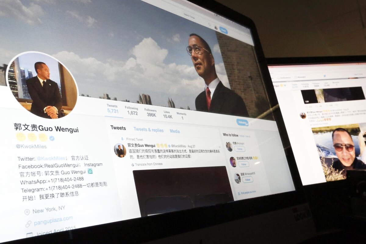 Guo Wengui's Twitter page is seen on two computer screens. 
