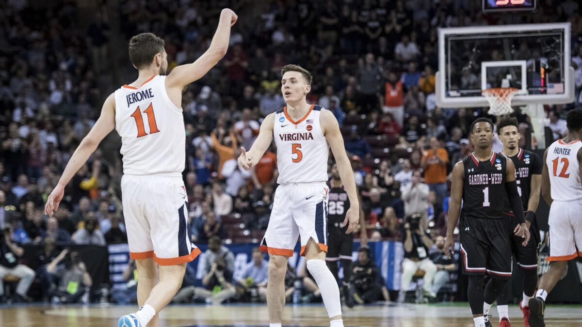 Virginia guard Kyle Guy (5) and Ty Jerome (11) celebrate after a score against Gardner-Webb.