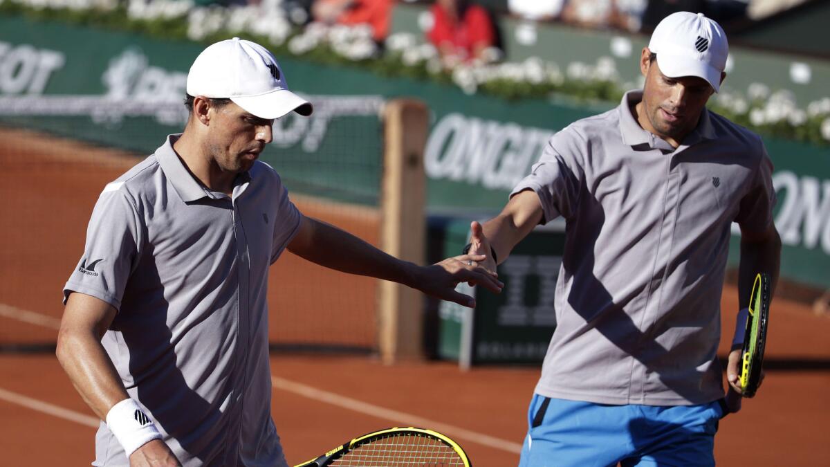 Bob, left, and Mike Bryan celebrate a point during their French Open doubles final match at Roland Garros in Paris on June 6.