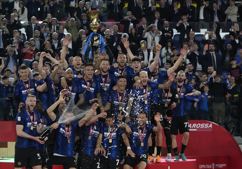 Inter players holds the trophy and celebrates after winning the the Italian Cup final soccer match between Juventus and Inter Milan at the Stadio Olimpico in Rome, Italy, Wednesday, May 11, 2022. (AP Photo/Alessandra Tarantino)