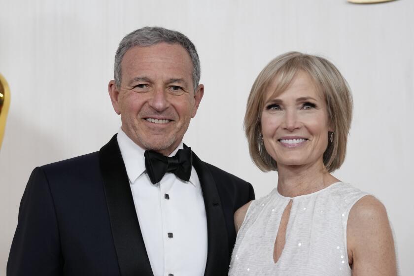 FILE - Bob Iger, left, and Willow Bay arrive at the Oscars on Sunday, March 10, 2024, at the Dolby Theatre in Los Angeles. Angel City FC announced Wednesday, July 17, 2024, that Walt Disney Company CEO Bob Iger and Southern California dean for communication and journalism Willow Bay will be the new controlling owners of what the franchise calls the most valuable women’s sports team in the world. (AP Photo/Ashley Landis, File)