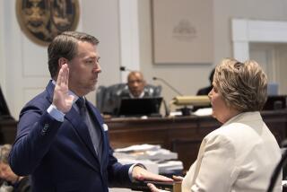 FILE - Michael Gunn, principle at Forge Consulting, gives the witness oath by Colleton County Clerk of Court Rebecca Hill, right, during Alex Murdaugh's double murder trial at the Colleton County Courthouse, Feb. 8, 2023, in Walterboro, S.C. On Tuesday, Sept. 5, Murdaugh's lawyers filed a request for a new trial, saying Hill influenced jurors by telling them not to be fooled by the defense's evidence during the trial and had private conversations with the jury foreperson. (Andrew J. Whitaker/The Post And Courier via AP, Pool, File)