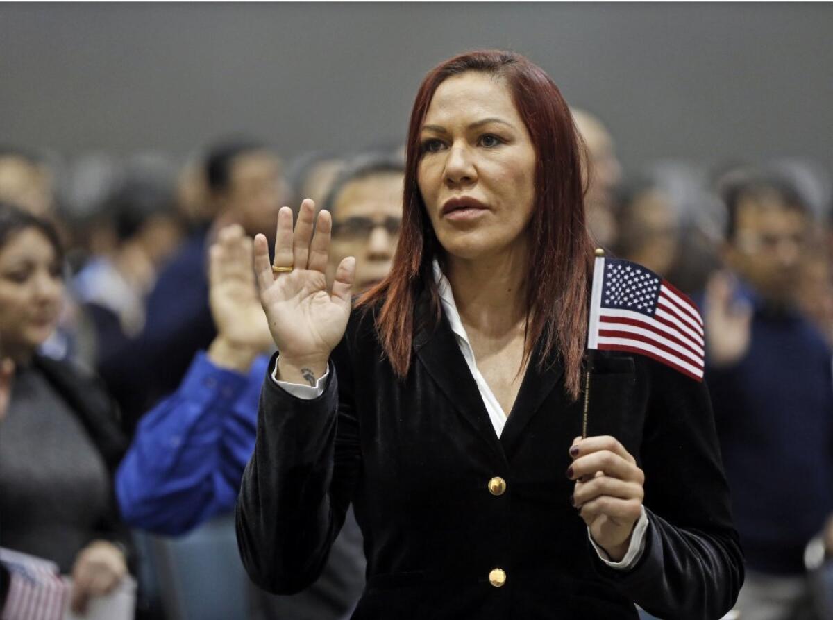 Brazilian UFC fighter Cris Justino takes the oath of citizenship to become a U.S. citizen during a naturalization ceremony at the Los Angeles Convention Center on Dec. 13, 2016.