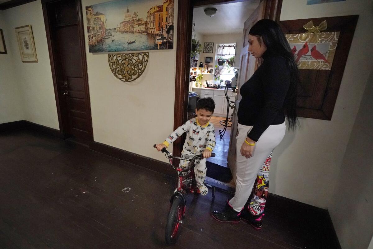Isabel Miranda's 4-year-old son, Julian, rides his bike in their rental apartment in Haverhill, Mass. 