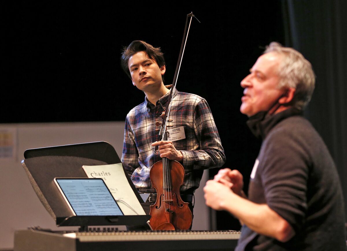 Pianist Jeremy Denk, right, talks music with kids as violinist Stefan Jackiw joins him at Thurston Middle School Thursday.