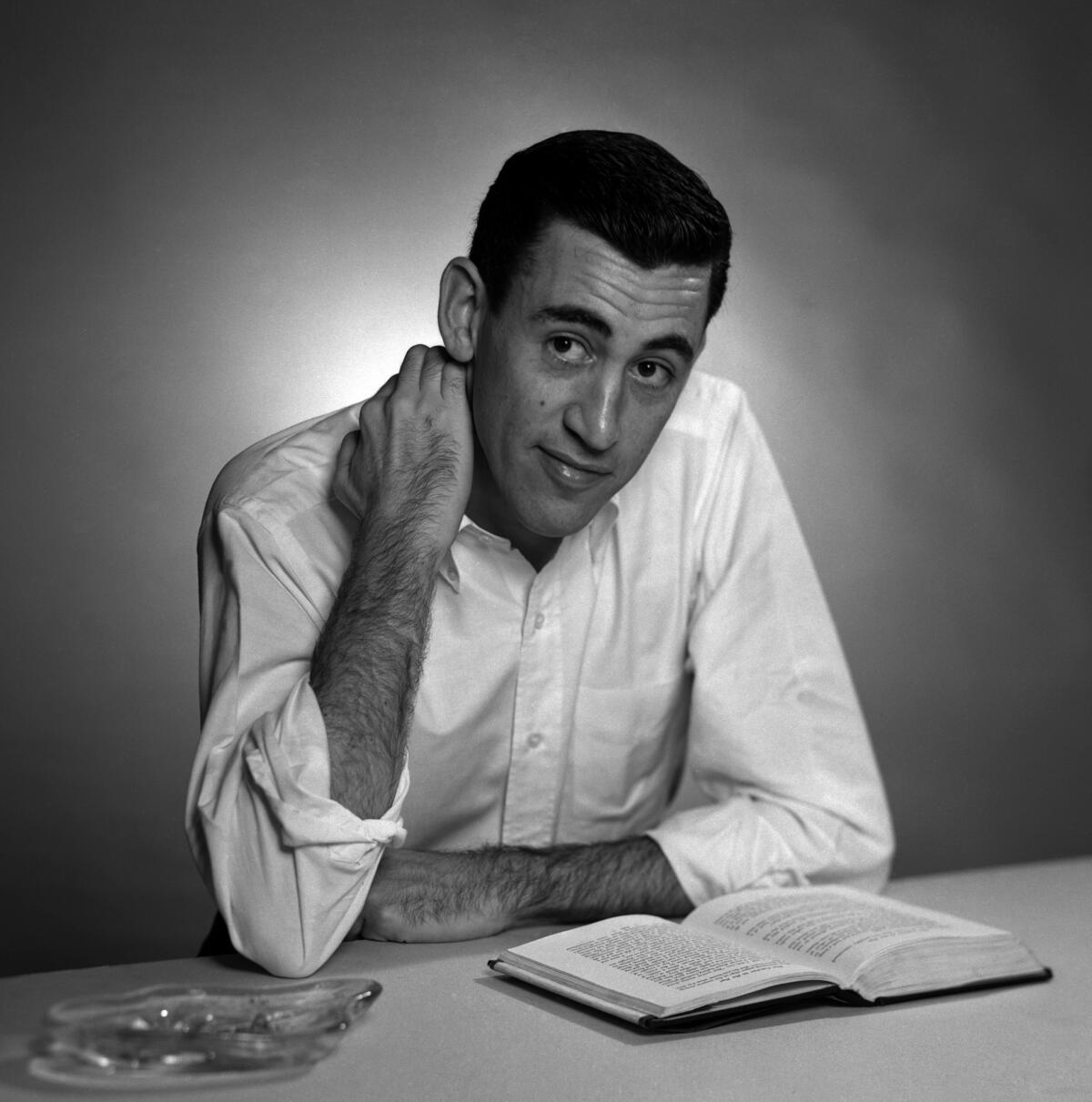 Author J.D. Salinger poses for a portrait as he reads from his novel "The Catcher in the Rye" in Brooklyn in 1952. Salinger died in 2010, but this year, three of his unpublished stories were surreptitiously published online.
