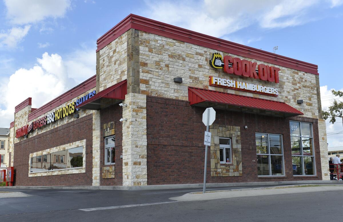 The exterior of the Cook Out restaurant where Trinity Gay, the 15-year old daughter of Olympian and Lexington native Tyson Gay was shot and killed early Sunday morning, Oct. 16, 2016, in the parking lot of the restaurant, in Lexington, Ky. Lexington police said in a statement that officers went to the parking lot of the restaurant about 4 a.m. Sunday after witnesses reported an exchange of gunfire between two vehicles. Police spokeswoman Brenna Angel said police don't believe Trinity Gay was in either of the vehicles involved. (AP Photo/Timothy D. Easley)