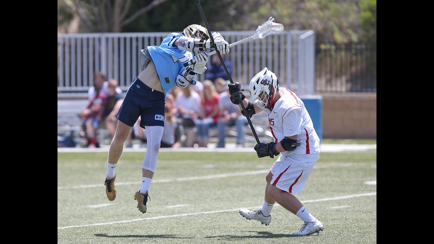 Corona del Mar High's Chandler Fincher, left, shoots and scores against San Clemente during boys' lacrosse game on Saturday.