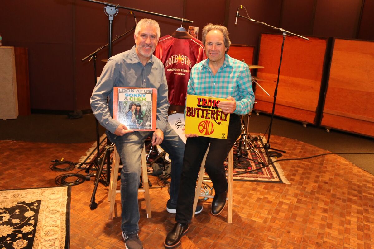 Brad Ross, left, and Jonathan Rosenberg display album covers for music that was recorded in Gold Star Recording Studios, which was co-founded and operated by Ross’ father, the late Stan Ross. The son and Rosenberg co-wrote a musical that will staged by the San Diego Repertory Theater in August.