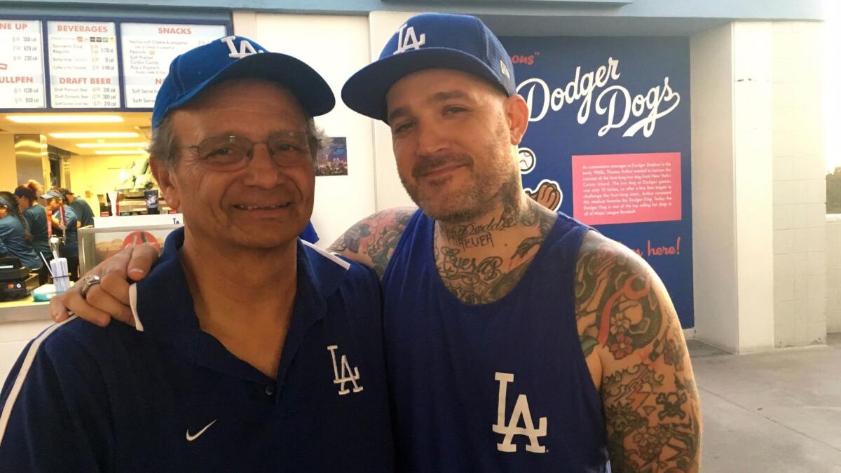 Charles Cuevas, 62, and his son, Collin Cuevas, 38, at the Dodgers' last regular-season home game on Sept. 27.