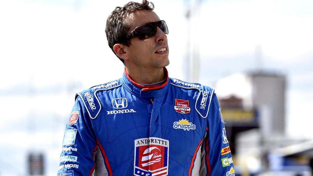 Justin Wilson walks on pit road during qualifying for the IndyCar race at Pocono.
