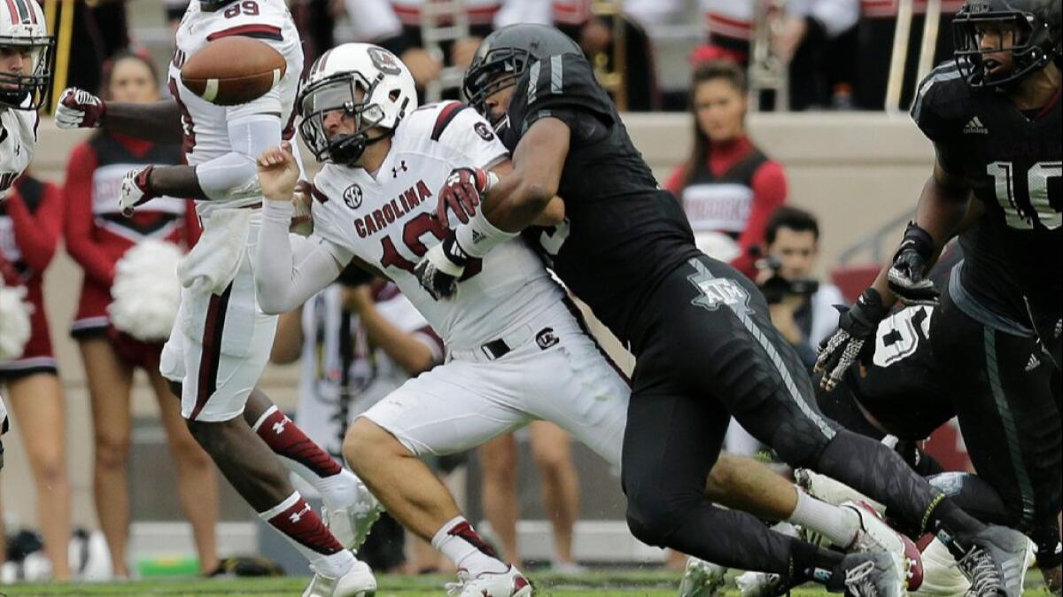 South Carolina quarterback Perry Orth (10) loses the ball as he's hit by Texas A&M defensive lineman Myles Garrett during the second half of a game last season.