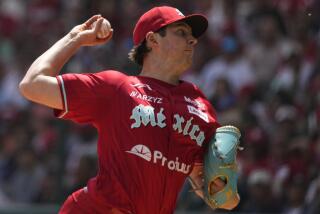 Diablos Rojos' Trevor Bauer throw a pitch during a baseball game