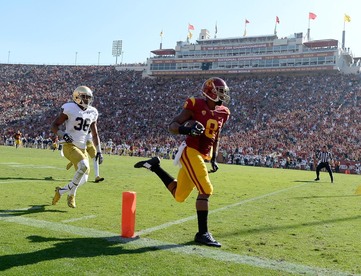 USC receiver George Farmer won this race to the end zone against Notre Dame just as he won a contest against teammates after practice on Christmas Day in San Diego.
