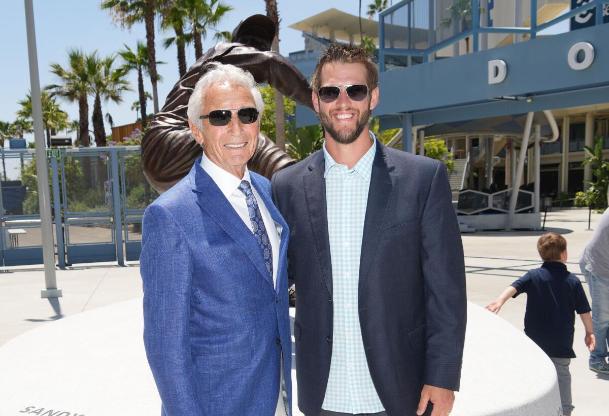 Dodgers legend Sandy Koufax stands next to Dodgers pitcher Clayton Kershaw during the Koufax statue unveiling.