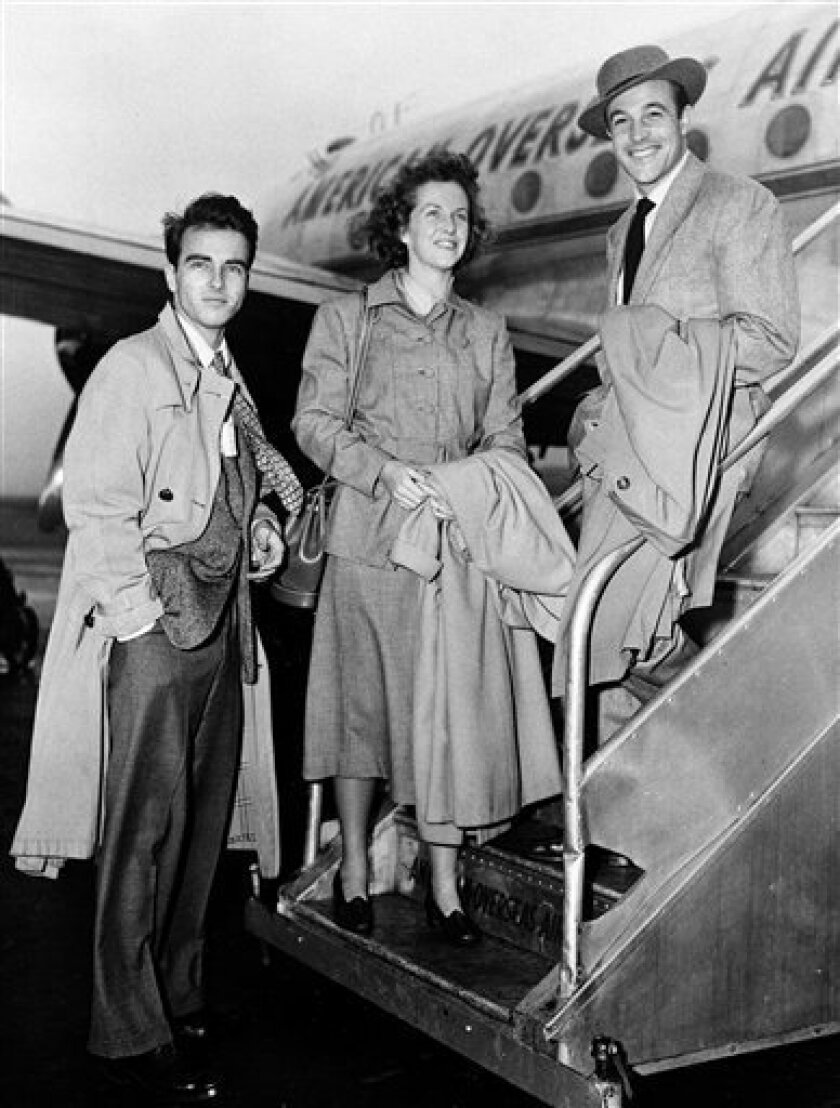 In this Nov. 1948, file photo, actress Betsy Blair is flanked by actors Montgomery Clift, left, and Gene Kelly as they board an airplane for London at La Guardia Airport in New York City. Betsy Blair, the Oscar-nominated actress and teenage bride of Gene Kelly, has died in London at the age of 85, her publisher said on Thursday, March 19, 2009. The New Jersey-born actress, who later married film Karel Reisz, suffered from cancer and died on March 13. Mark Searle, the publisher of Blair's 2003 autobiography, confirmed her death. (AP Photo/file )