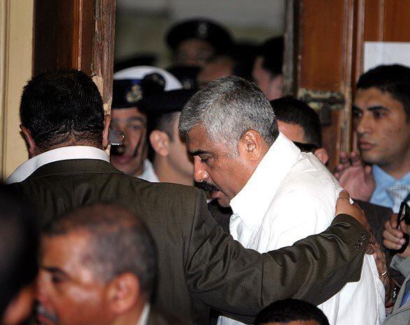 Hisham Talaat Mustafa is led into the defendants cage during his trial in Cairo, Egypt. The billionaire developer and former member of the Egyptian Parliament was sentenced to death for his role in the murder of Lebanese pop diva Suzanne Tamim.