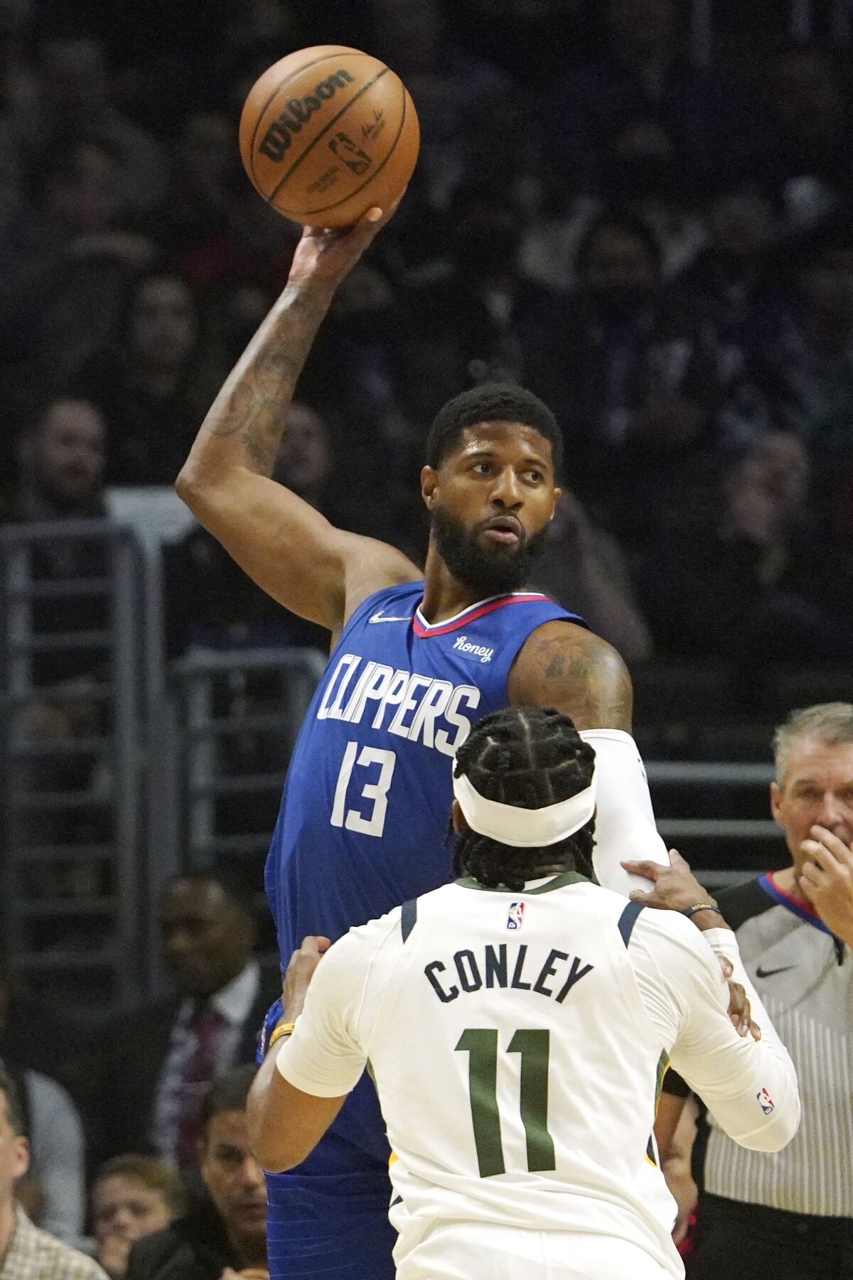 Clippers guard Paul George tries to pass while under pressure from Utah Jazz guard Mike Conley.
