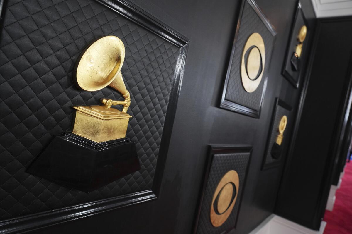 Images of Grammy Awards and the CBS logo in gold on a black backdrop for red carpet photos