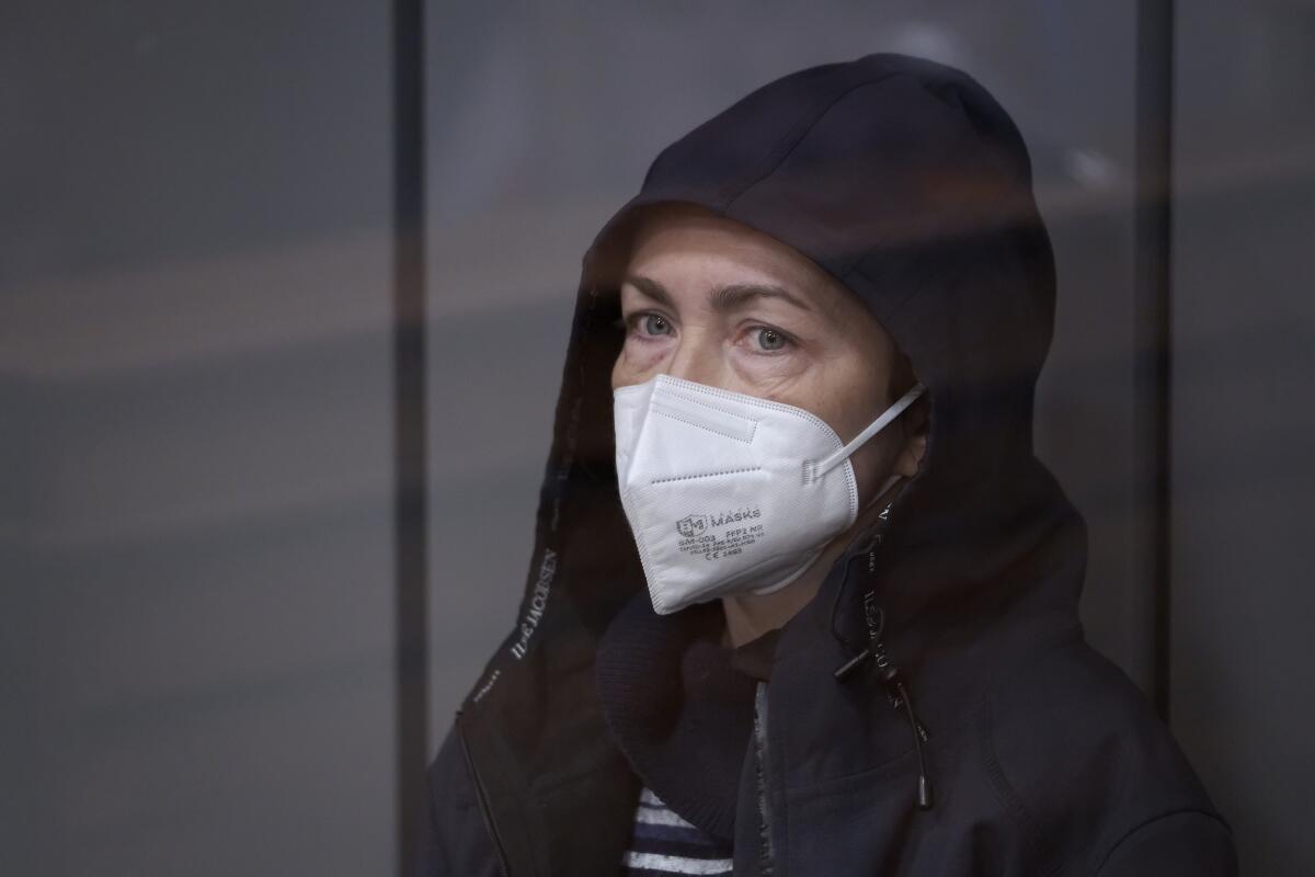 Radio Free Europe/Radio Liberty editor Alsu Kurmasheva sits in a glass cage in a courtroom in Kazan, Russia.