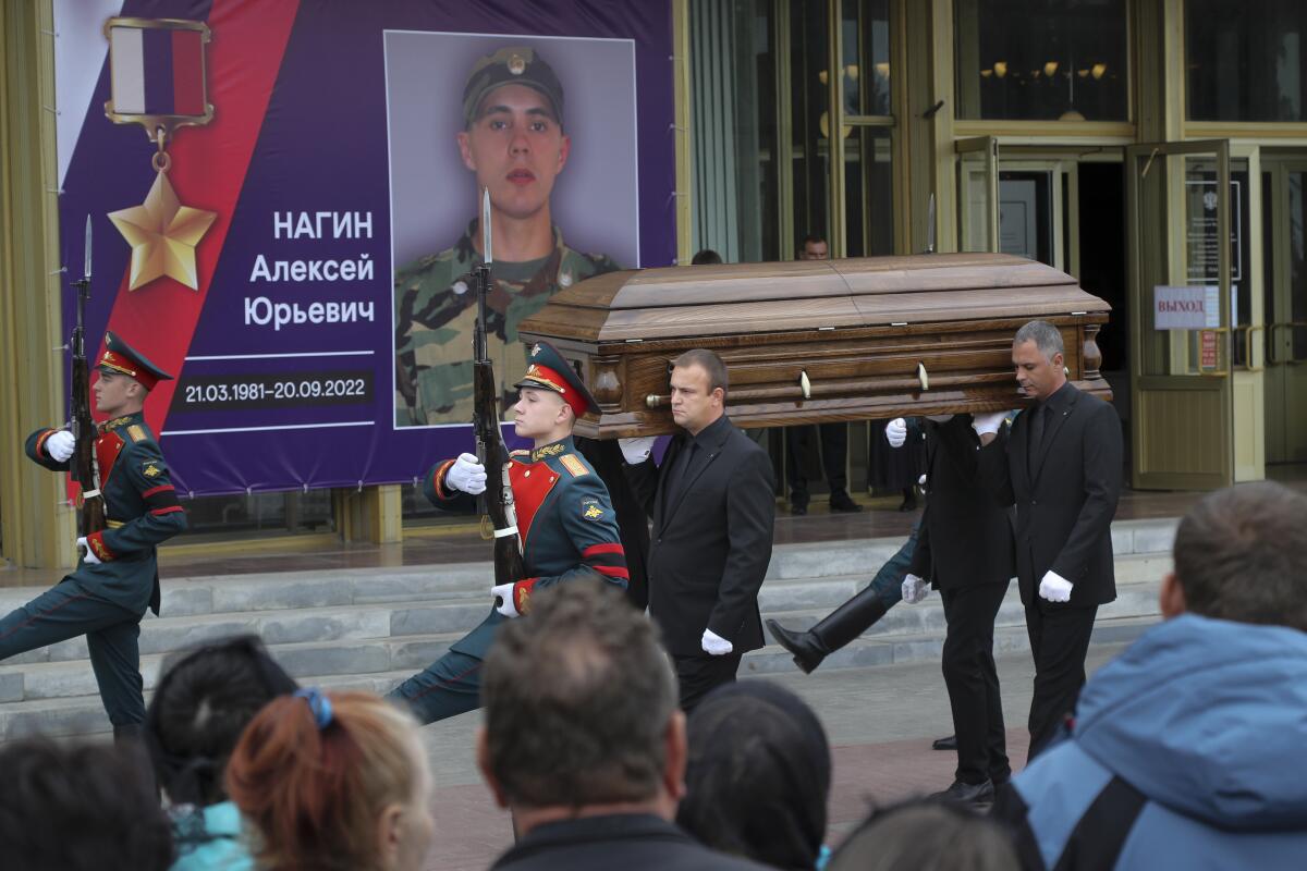 Coffin of Russian fighter being carried by honor guard