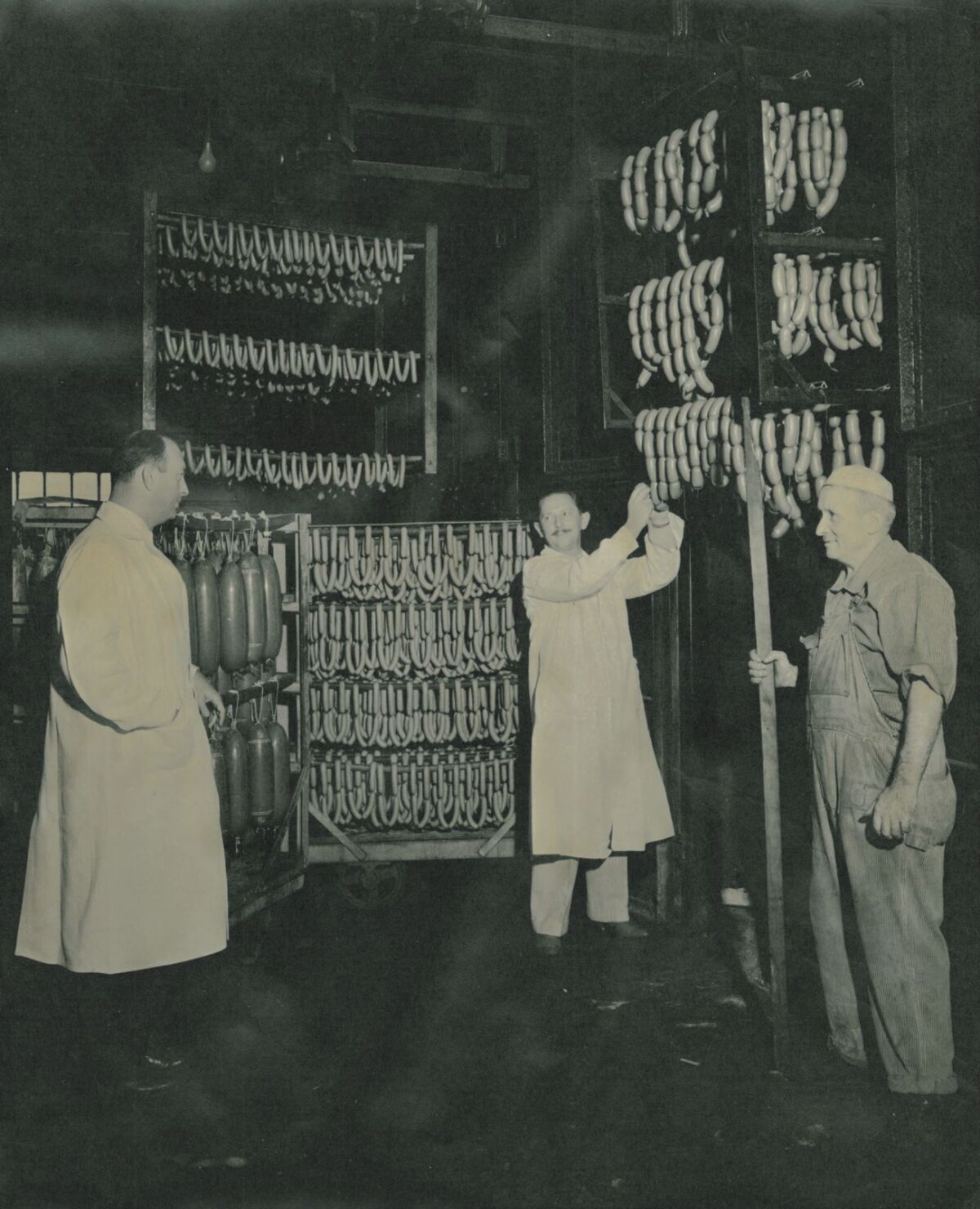Sausage is inspected at a factory.