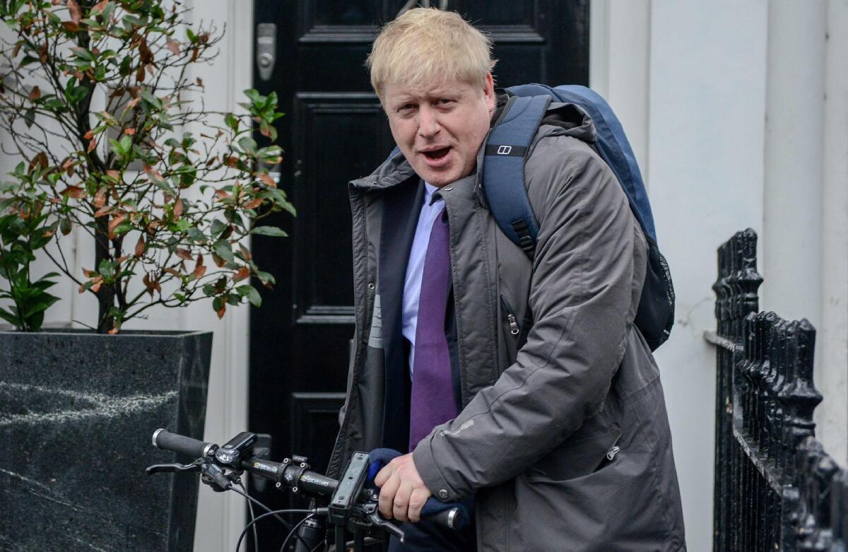 London Mayor Boris Johnson leaves his home by bicycle on Monday.
