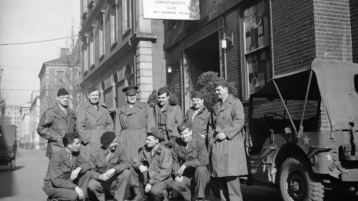 Morrie Landsberg, kneeling at bottom left, is shown with other journalists outside the Tokyo correspondents' club on Jan. 31, 1946.