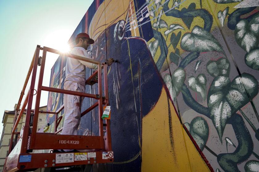 Taylor Gallegos paints a mural in East Village honoring Makeda