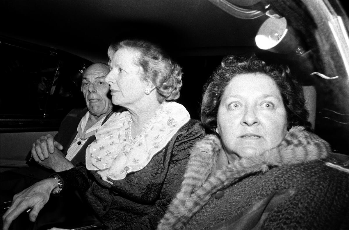 Three people sit in a car