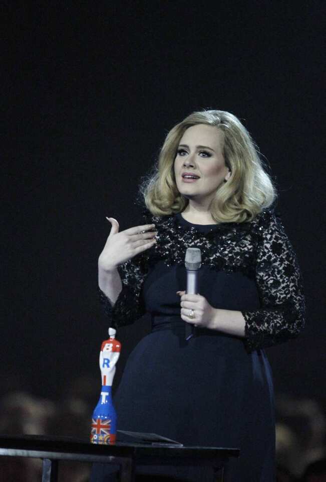 Adele's moment in the spotlight ended on a sour note on Tuesday at the Brit Awards when her album of the year acceptance speech was cut short. While apologetic host James Corden tried to usher her off stage to make time for Blur, Adele became upset, eventually signing off with, "Can I just say then, goodbye, and I'll see you next time round, then." And then she gave the crowd the middle finger. Despite hubbub over who she was directing the offending finger at, the singer insists it was meant for the "suits."